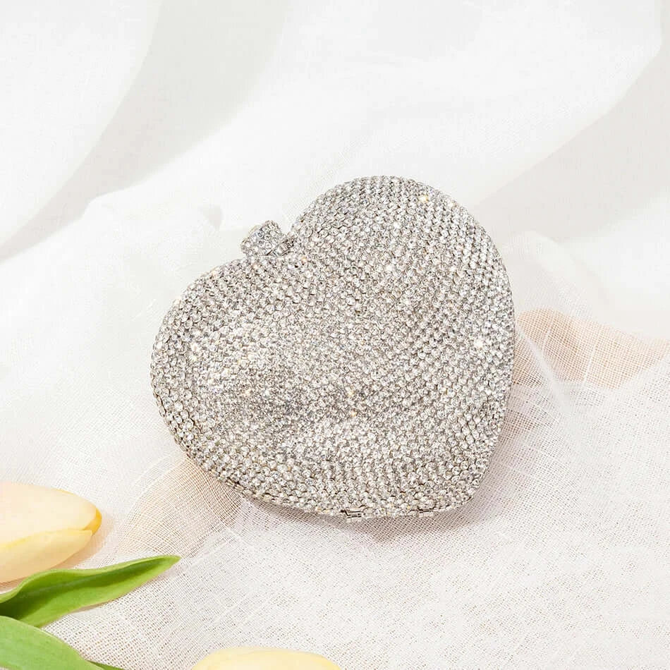 Silver heart-shaped crystal clutch bag, perfect for sorority and fraternity events, showcasing elegant rhinestone design.