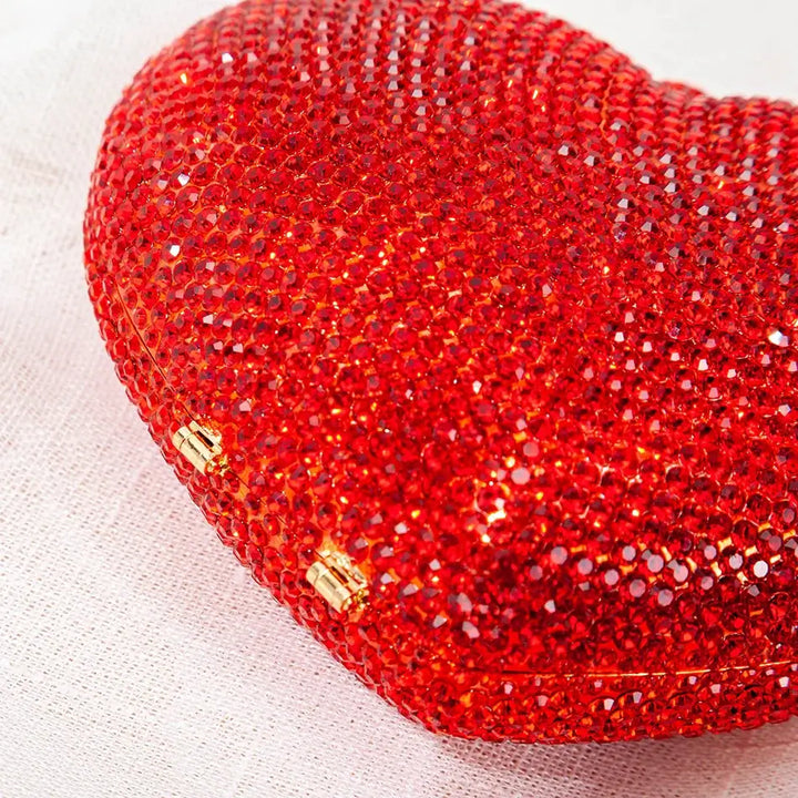 Dazzling red heart-shaped crystal evening clutch bag, perfect for sorority and fraternity events, adding sparkle to Greek gear.