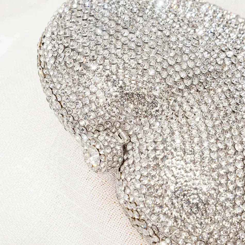 Silver heart-shaped crystal evening clutch bag, perfect accessory for sorority and fraternity events, showcasing elegant rhinestone design.