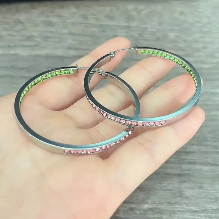Pink and green rhinestone hoop earrings, perfect for sorority and fraternity gear, adding sparkle to any outfit.