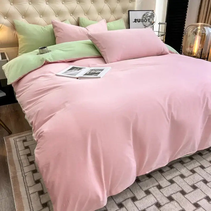 Luxurious pink and green duvet bedding set with soft pillows, perfect for sorority and fraternity decor, creating a cozy bed.