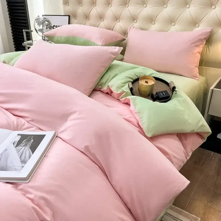 Luxurious pink and green duvet bedding set with soft pillows, perfect for cozy sorority or fraternity-themed bedrooms.