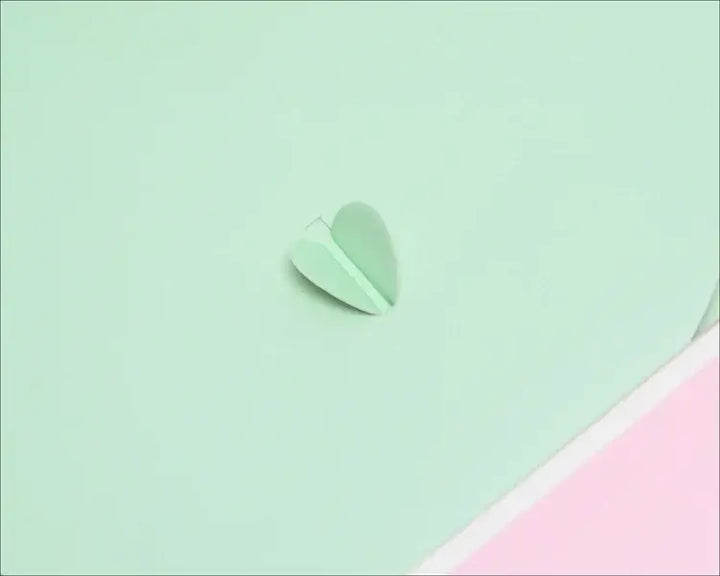 Close-up of a mint green gift box detail featuring a decorative heart cutout, perfect for Greek gear and sorority gifts.