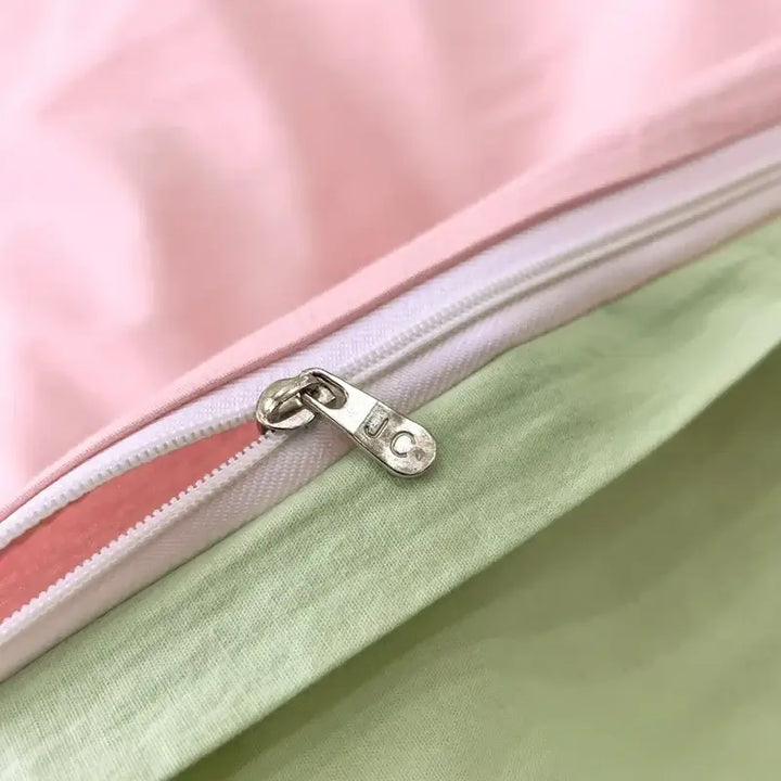 Close-up of pink and green duvet cover zipper, showcasing the soft fabric and quality craftsmanship perfect for sorority and fraternity rooms.