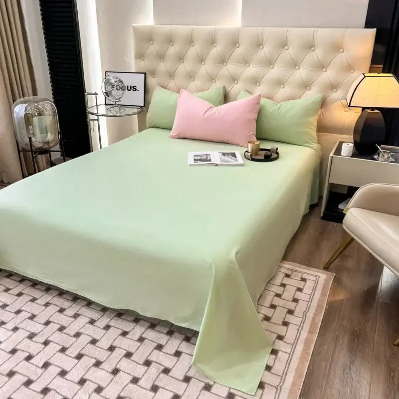 Luxurious pink and green duvet bedding set on styled bed for cozy and stylish bedroom decor. Perfect for sorority and fraternity themes.