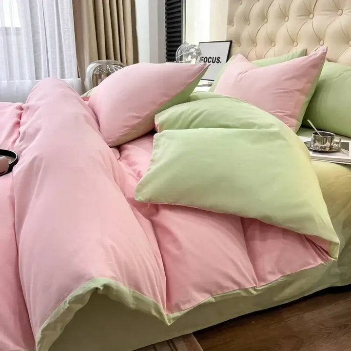 Luxurious pink and green duvet bedding set with pillows, perfect for sorority and fraternity themed rooms.