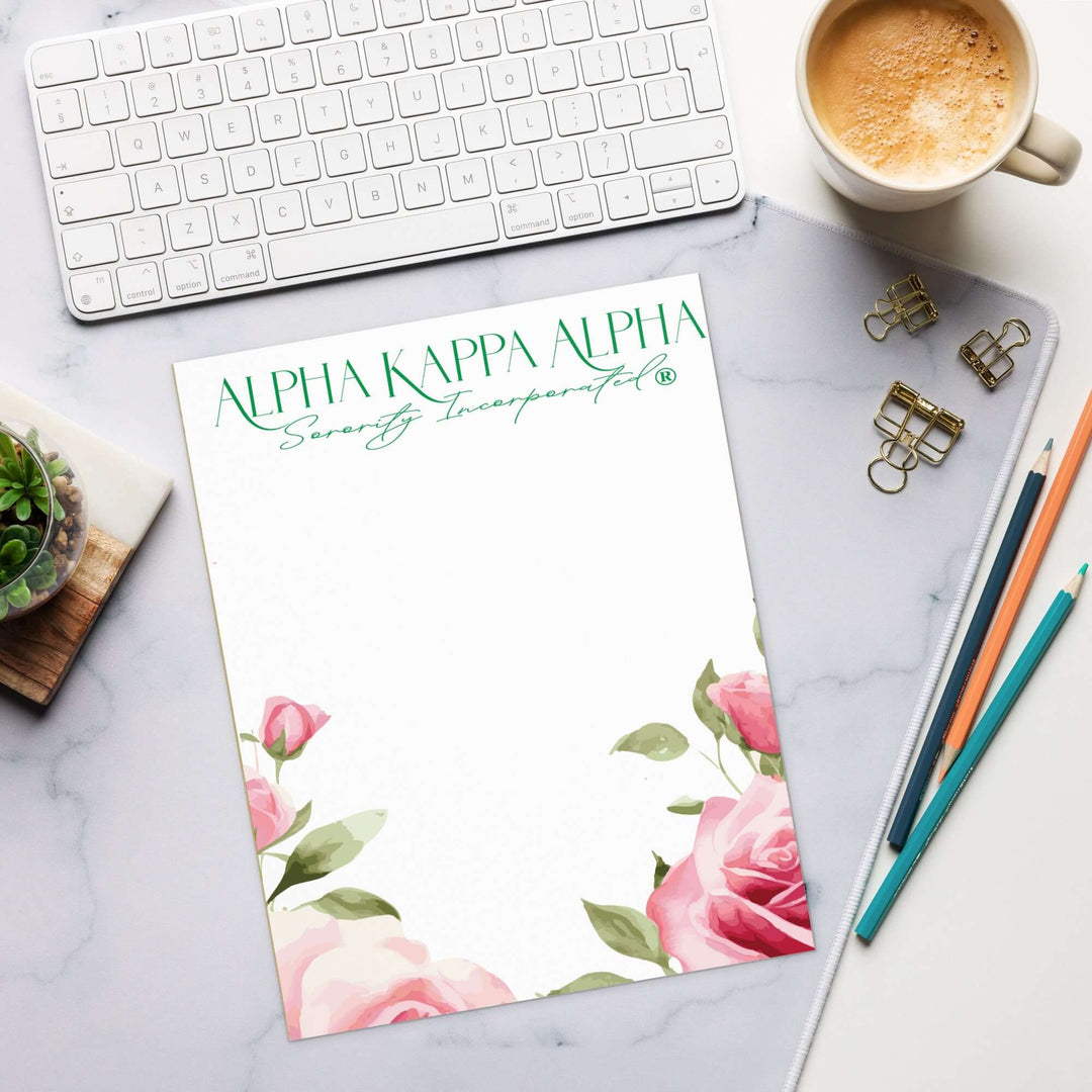 AKA Tea Rose notepad on a desk with keyboard and coffee, perfect for sorority notes and planning.