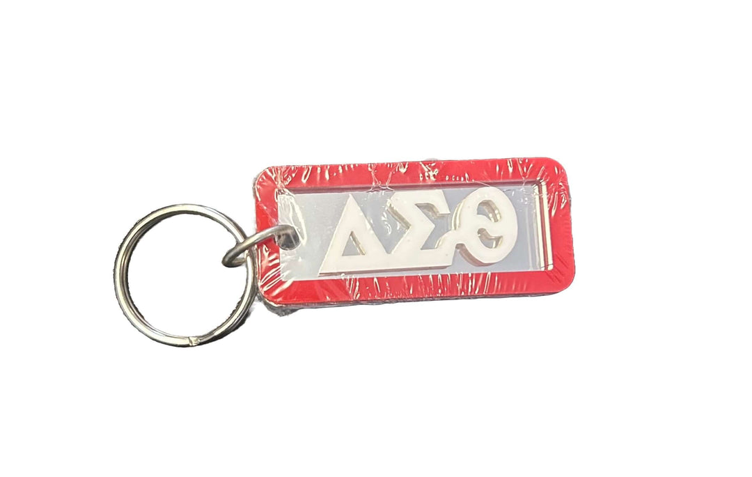 Delta keychain with Greek letters on mirrored acrylic, featuring a red trim for sorority and fraternity pride.