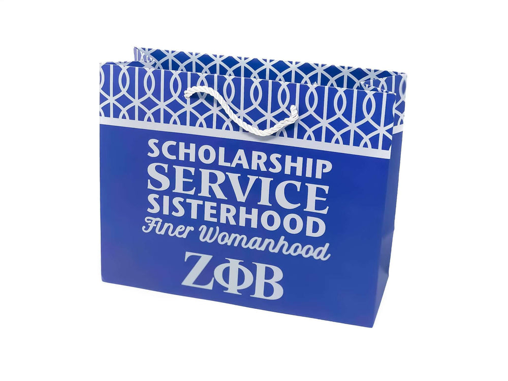 Blue Zeta gift bag featuring "Scholarship, Service, Sisterhood" for sorority and fraternity Greek gear.