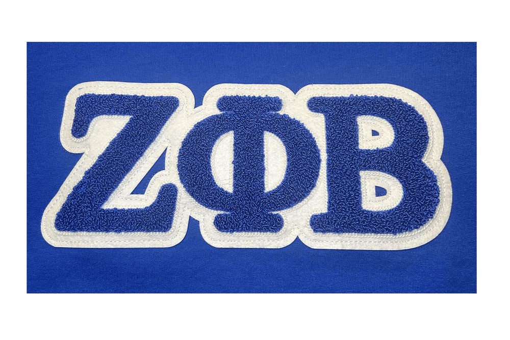 Zeta Phi Beta embroidered chenille patch on a royal blue sweatshirt, perfect for sorority paraphernalia and Greek gear.