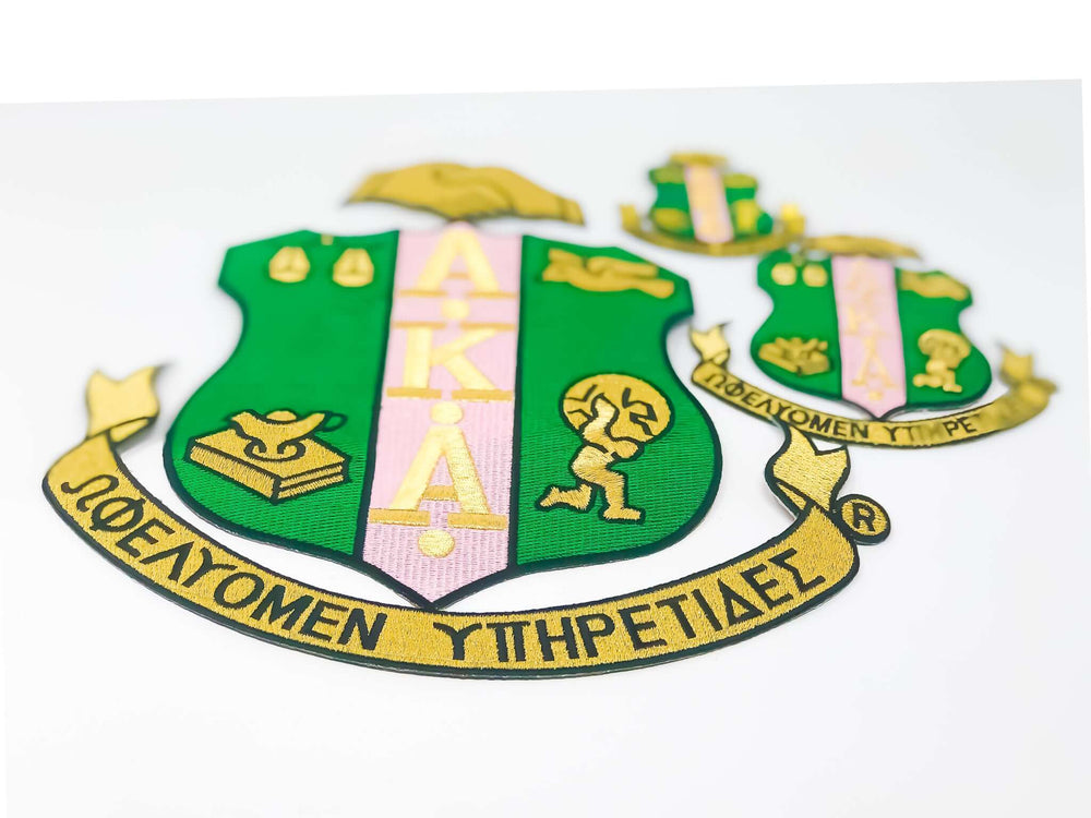 AKA Shield patches in green and gold, representing sisterhood and tradition for sorority and fraternity paraphernalia.