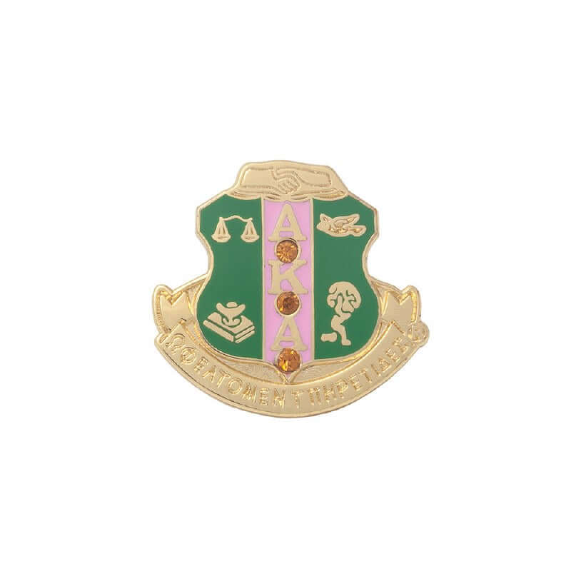 AKA Crest gold pin with pink and green accents, perfect for sorority and fraternity paraphernalia and Greek gear.