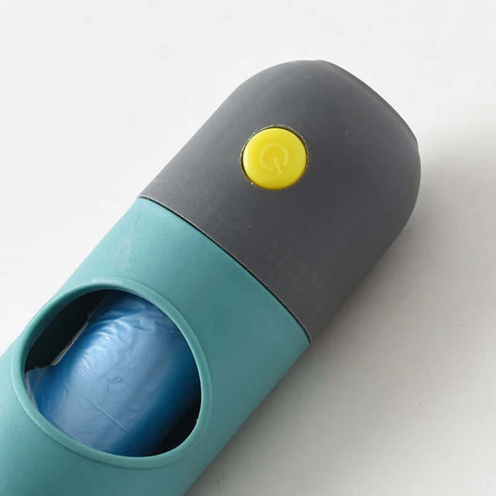 LED Light Pet Waste Bag Dispenser in teal and gray, featuring a button and visible waste bag for convenient pet clean-up.