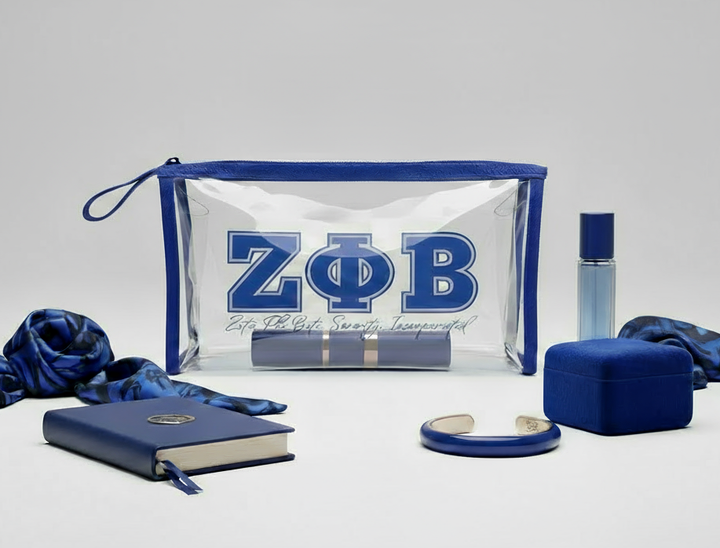 Zeta Phi Beta clear cosmetic bag with royal blue trim styled with sorority travel accessories by A&W Greek Shop, durable TSA-approved pouch.
