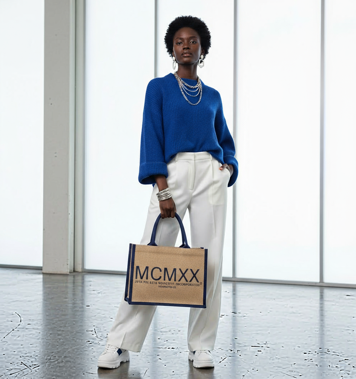 Zeta Phi Beta MCMXX jute tote bag held by model styled in trendy royal blue and white outfit and accessories, design by A&W Greek Shop.